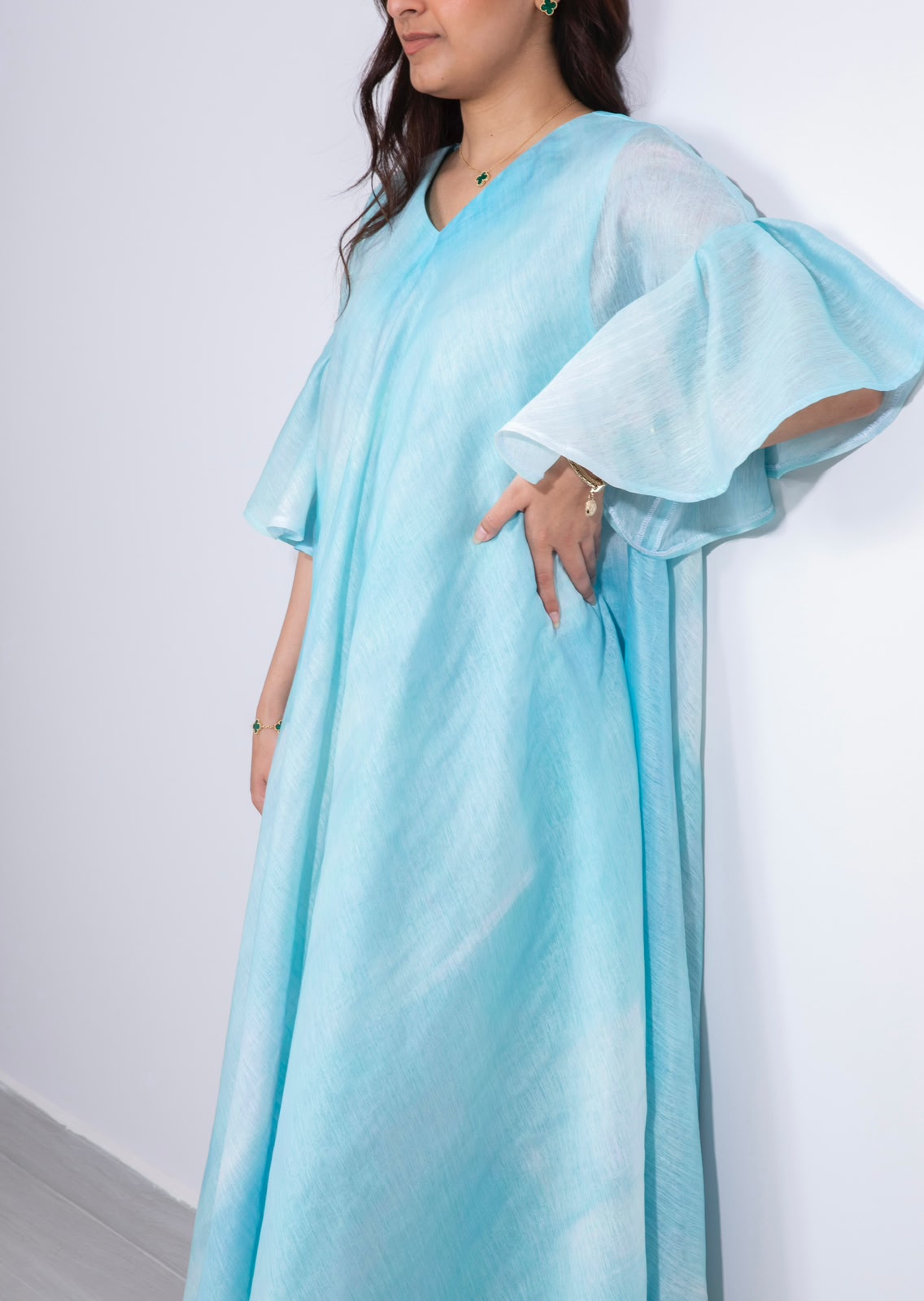 Detail of the watercolour print and V-neckline on the Aqua Flutter kaftan